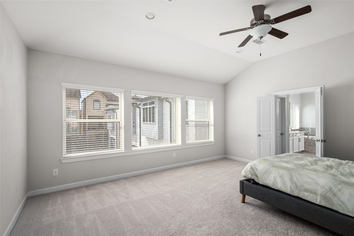 8923 Highgate Lane Houston, TX 77080 - Photo 10 of 23 Spacious primary suite featuring large windows and a private en-suite bathroom.