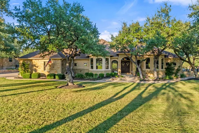 a view of a house with swimming pool and sitting area