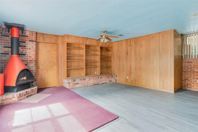 a view of a chair and table in the back yard of the house