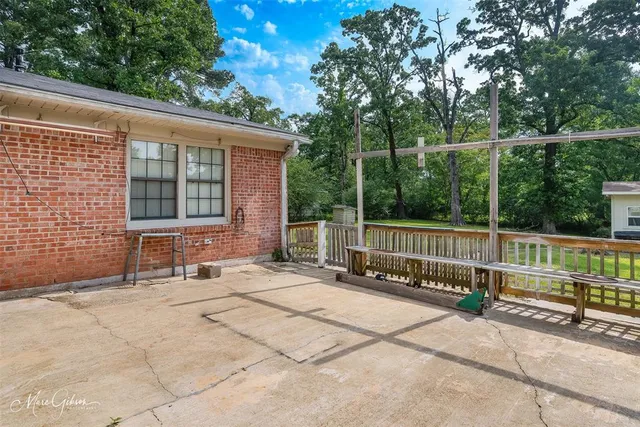 a backyard of a house with table and chairs