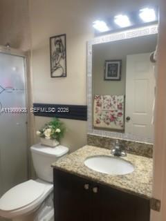 1394 West 30th Street Hialeah, FL 33012 - Photo 14 of 21 a bathroom with a granite countertop sink a mirror and a toilet