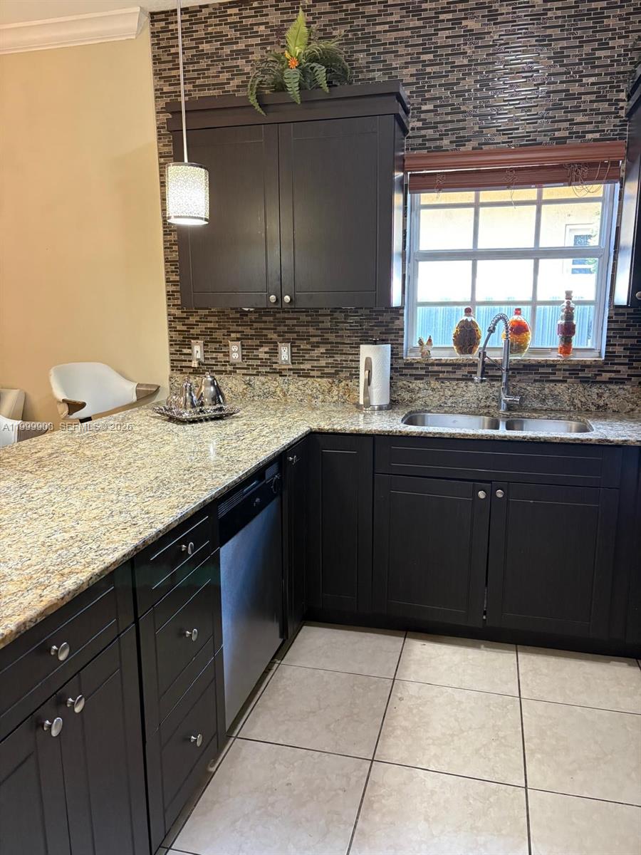 1394 West 30th Street Hialeah, FL 33012 - Photo 8 of 21 a kitchen with a sink a counter top space and cabinets