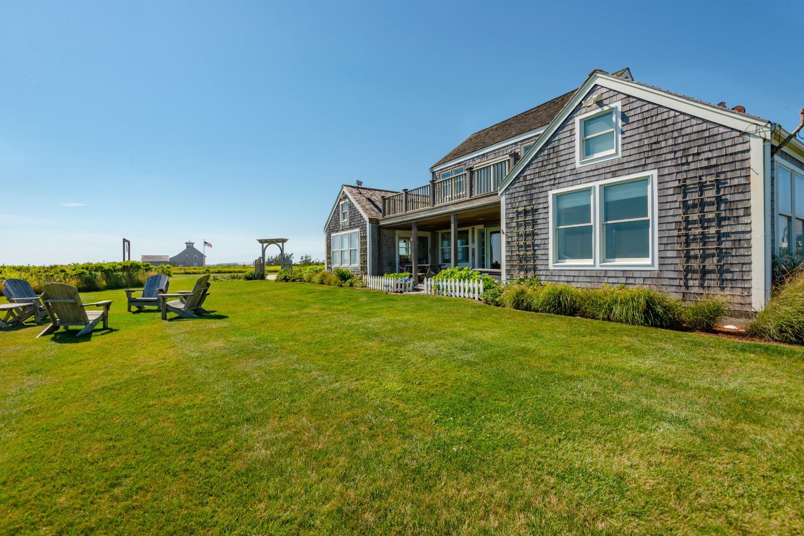 56 R Madequecham Valley Road Nantucket, MA 02554 - Photo 8 of 52 a front view of a house with a yard