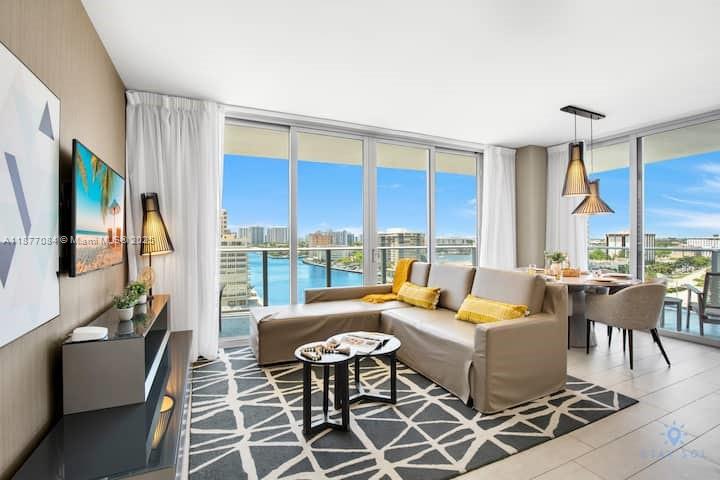 4010 South Ocean Drive, Unit R708 Hollywood, FL 33019 - Photo 1 of 30 a living room with furniture a fireplace and a large window