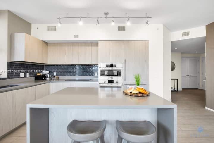 4010 South Ocean Drive, Unit R708 Hollywood, FL 33019 - Photo 11 of 30 a kitchen with a sink refrigerator and cabinets