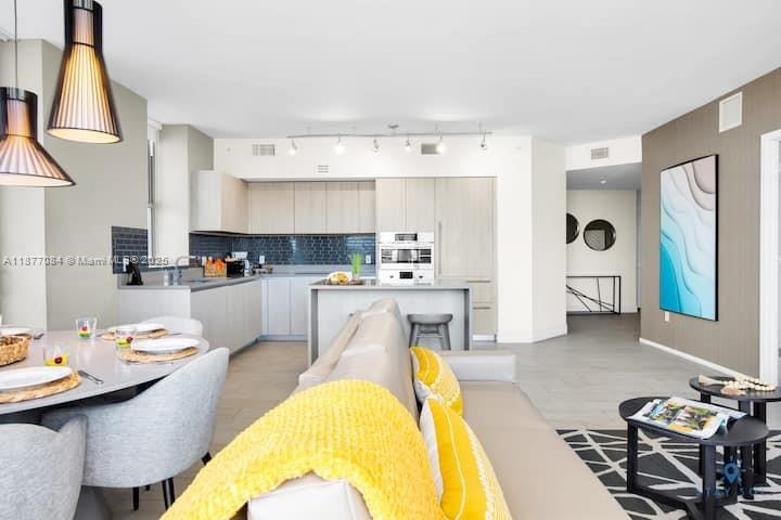 4010 South Ocean Drive, Unit R708 Hollywood, FL 33019 - Photo 15 of 30 a living room with stainless steel appliances kitchen island granite countertop furniture and a kitchen view