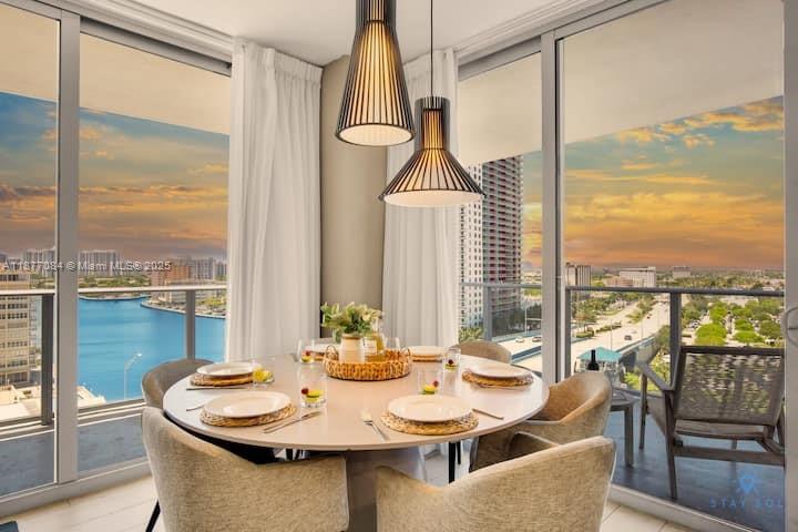 4010 South Ocean Drive, Unit R708 Hollywood, FL 33019 - Photo 16 of 30 a view of a dining room with furniture window and outside view