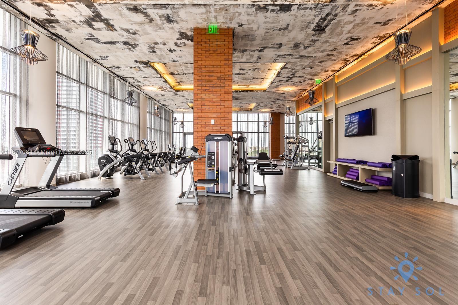 4010 South Ocean Drive, Unit R708 Hollywood, FL 33019 - Photo 20 of 30 a view of a gym with wooden floor and furniture