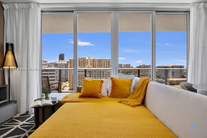 4010 South Ocean Drive, Unit R708 Hollywood, FL 33019 - Photo 3 of 30 a bedroom with furniture and a window