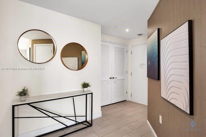 4010 South Ocean Drive, Unit R708 Hollywood, FL 33019 - Photo 6 of 30 a bathroom with a sink a mirror and a shower curtain