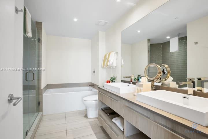 4010 South Ocean Drive, Unit R708 Hollywood, FL 33019 - Photo 7 of 30 a bathroom with a double vanity sink toilet mirror and bathtub