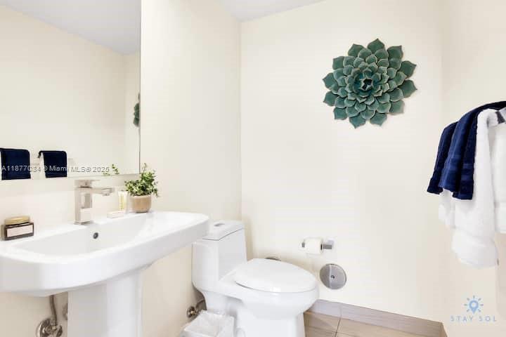 4010 South Ocean Drive, Unit R708 Hollywood, FL 33019 - Photo 9 of 30 a bathroom with a sink a toilet and mirror