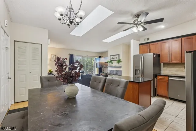 a kitchen with stainless steel appliances granite countertop a refrigerator stove microwave and sink