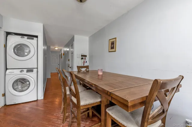 a view of a dining room that has a wooden floor and a table in it