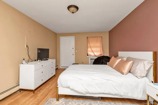a bedroom with a bed and flat screen tv