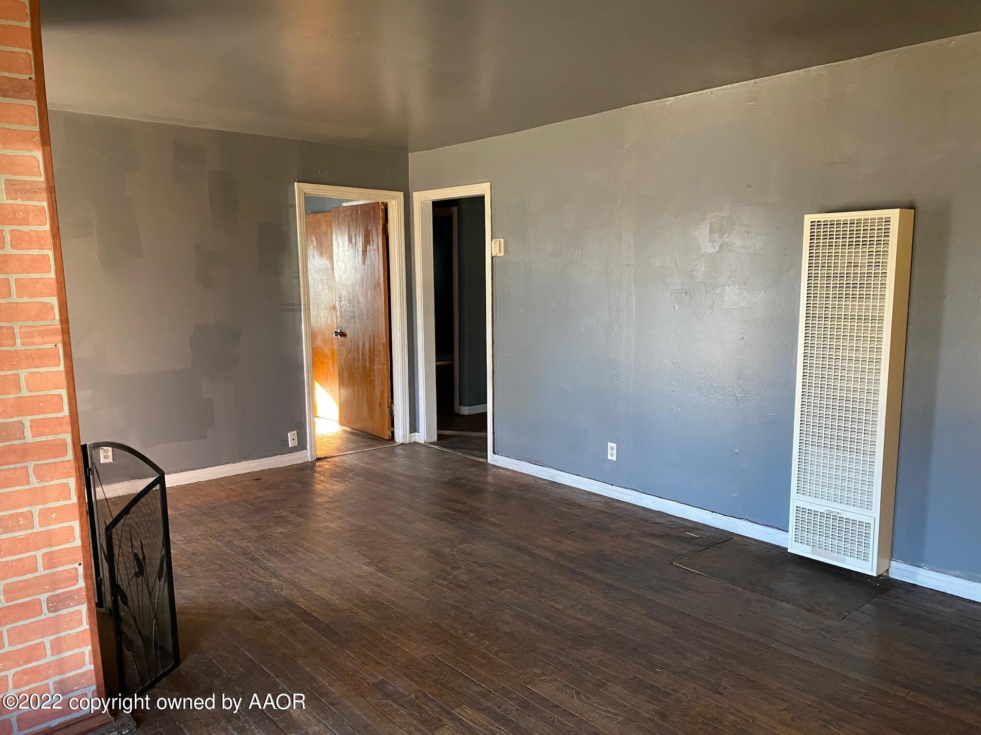 4323 South Washington Street Amarillo, TX 79110 - Photo 4 of 26 a view of an empty room with wooden floor and a window