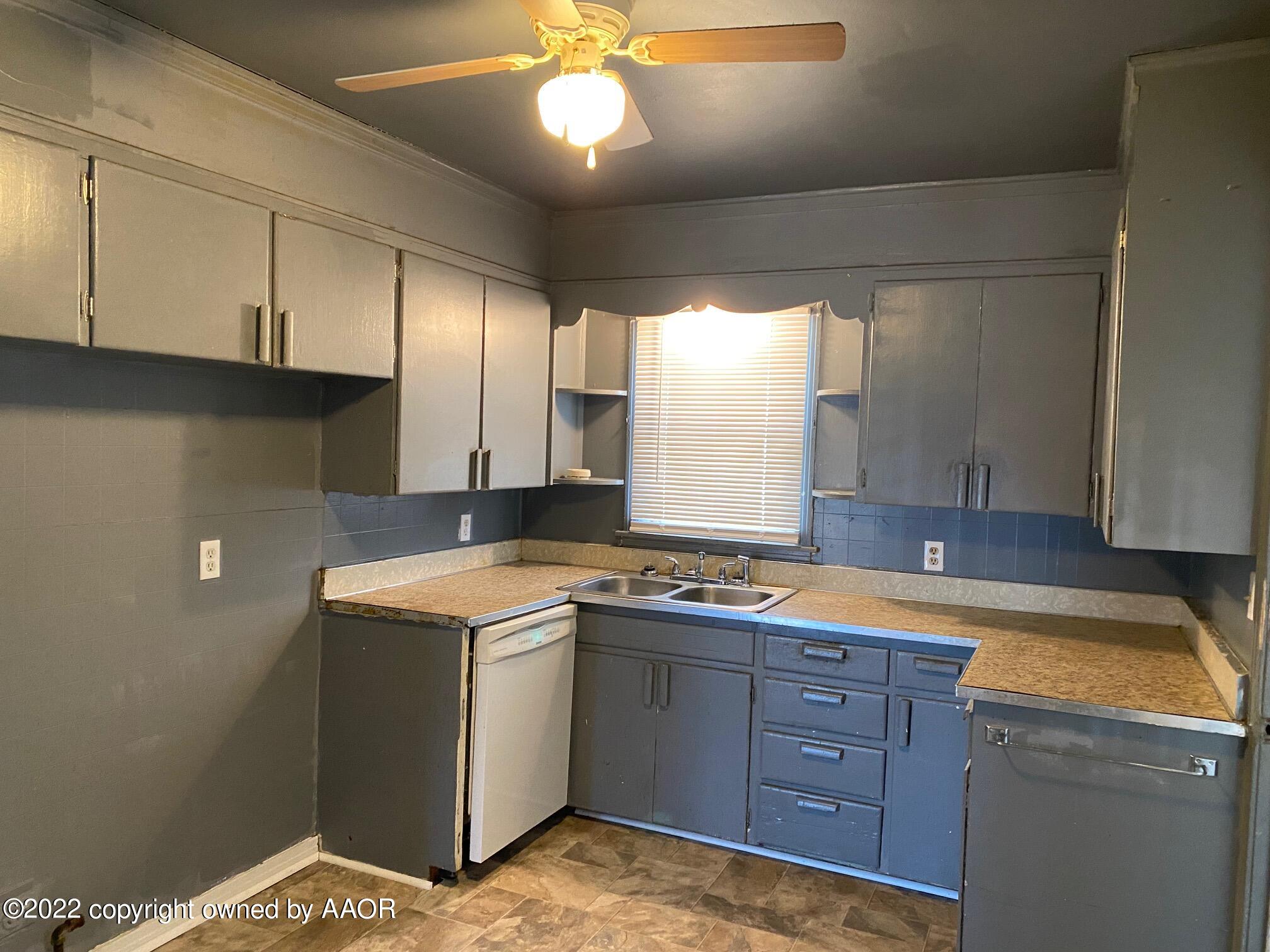 4323 South Washington Street Amarillo, TX 79110 - Photo 5 of 26 a kitchen with a stove cabinets and a sink