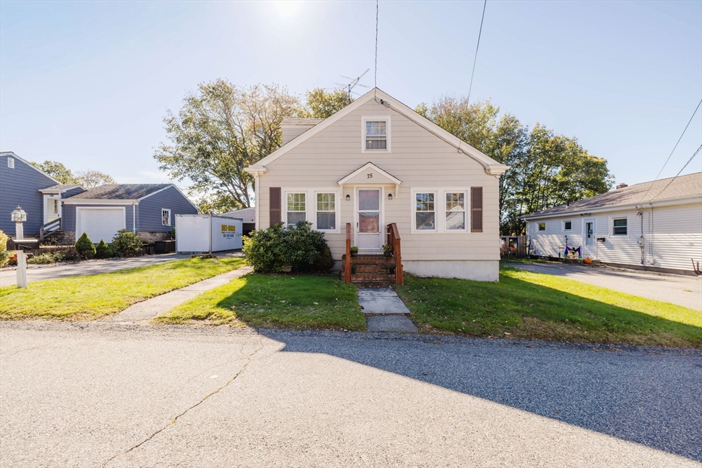 75 Randolph Avenue Tiverton, RI 02878 - Photo 1 of 22 a front view of a house with a yard and trees