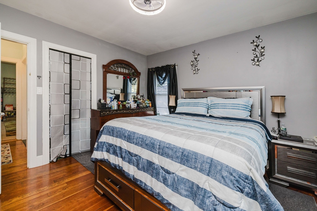 75 Randolph Avenue Tiverton, RI 02878 - Photo 12 of 22 a bedroom with a bed and a large mirror on the dresser