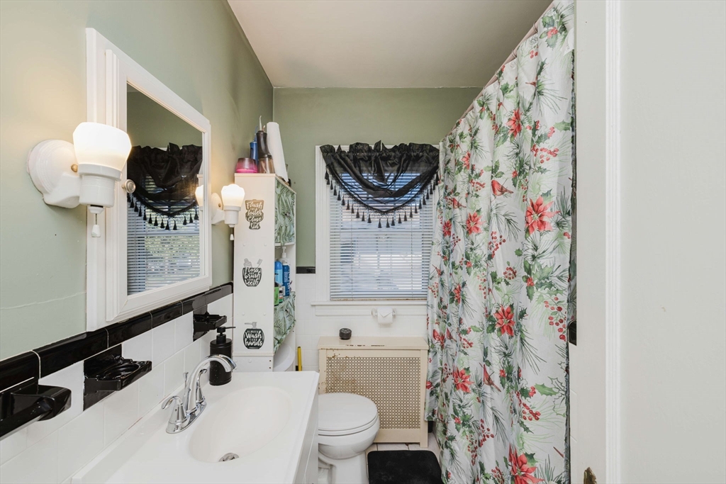 75 Randolph Avenue Tiverton, RI 02878 - Photo 15 of 22 a bathroom with a sink a toilet and a mirror