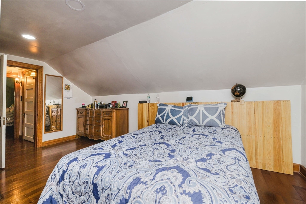 75 Randolph Avenue Tiverton, RI 02878 - Photo 18 of 22 a bed sitting in a bedroom and a table in a room