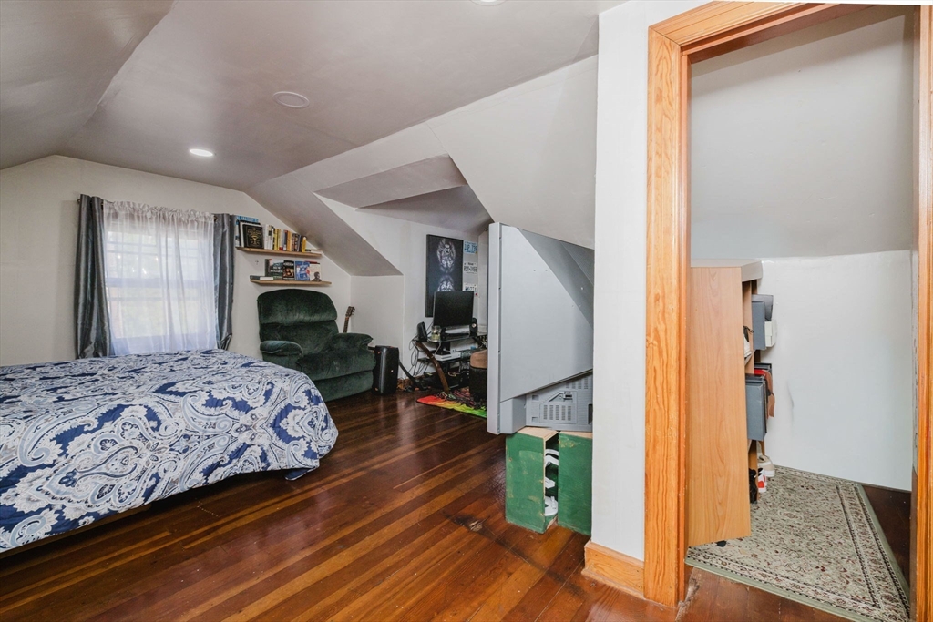 75 Randolph Avenue Tiverton, RI 02878 - Photo 19 of 22 a bedroom with a bed dresser and a large mirror