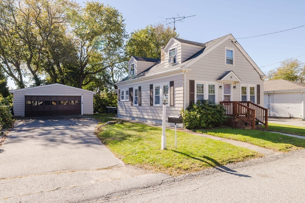 75 Randolph Avenue Tiverton, RI 02878 - Photo 3 of 22 a front view of a house with a yard table and chairs