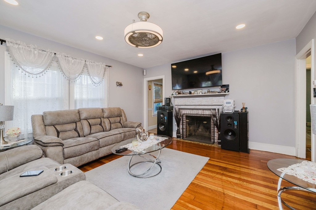 75 Randolph Avenue Tiverton, RI 02878 - Photo 6 of 22 a living room with furniture a flat screen tv and a fireplace