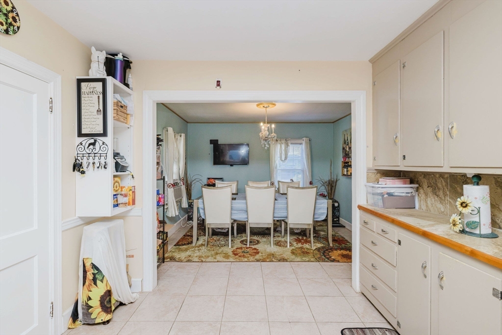 75 Randolph Avenue Tiverton, RI 02878 - Photo 8 of 22 a room with lots of white furniture and chandelier