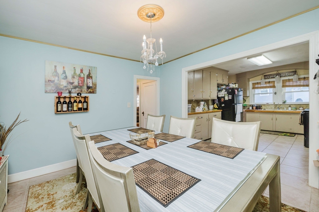 75 Randolph Avenue Tiverton, RI 02878 - Photo 9 of 22 a view of a dining room with furniture and a chandelier