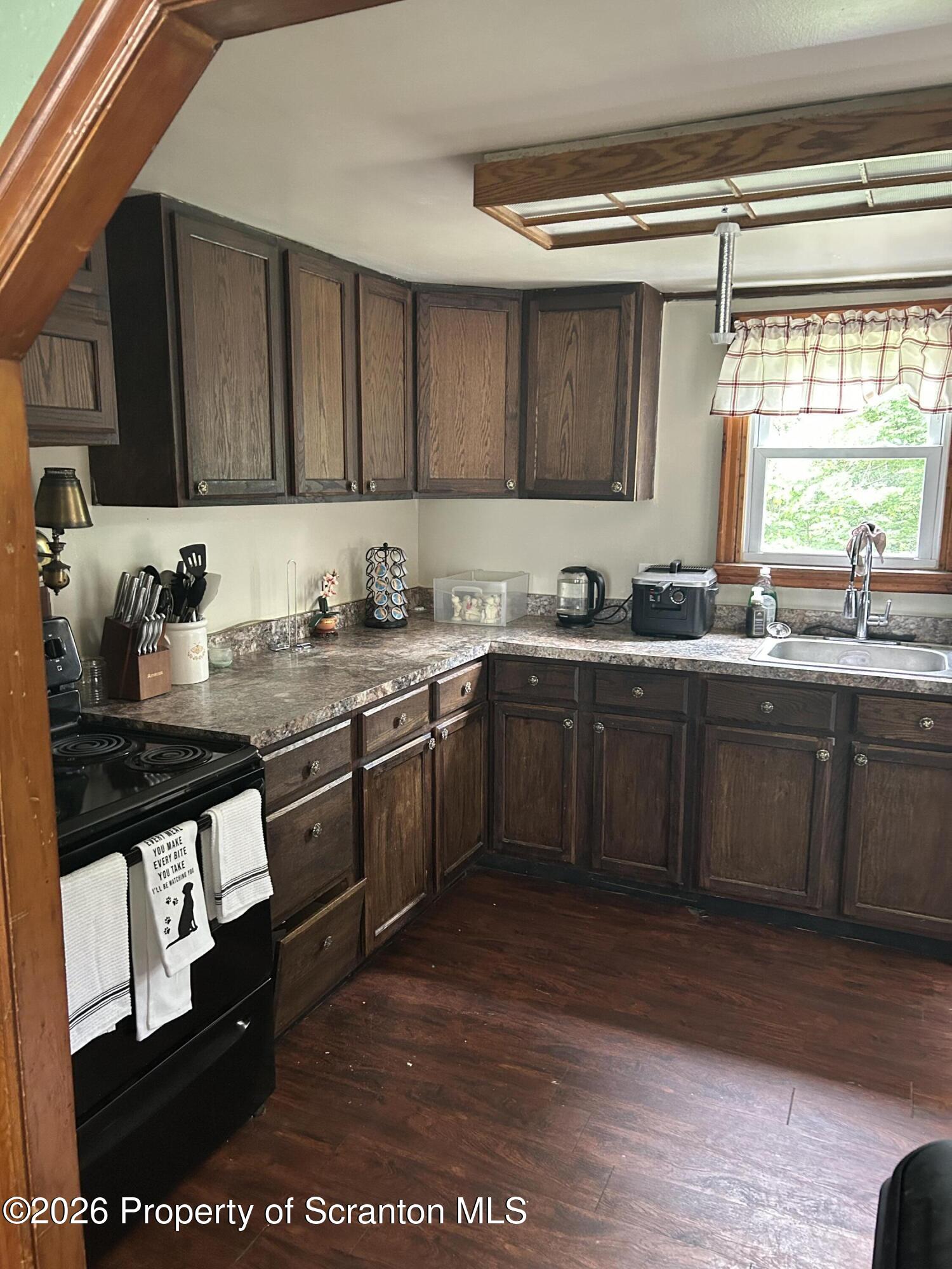 63 Shannon Street Simpson, PA 18407 - Photo 8 of 24 a kitchen with stainless steel appliances granite countertop a sink stove and cabinets