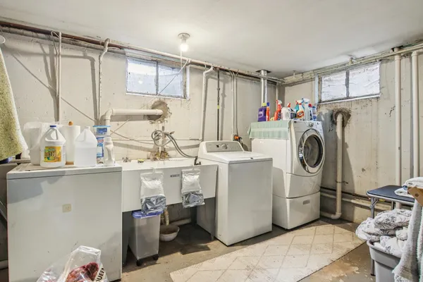 a view of kitchen with furniture and electronic appliances