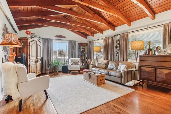 a living room with furniture and a wooden floor