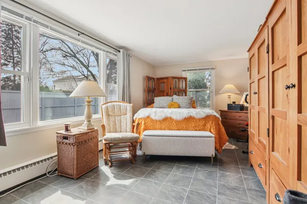 a bedroom with furniture and a window