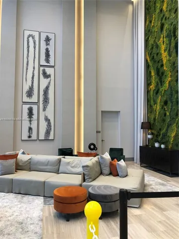 a living room with furniture and flowers