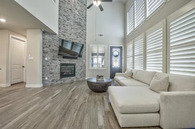 a kitchen with granite countertop kitchen island stainless steel appliances a sink and living room view