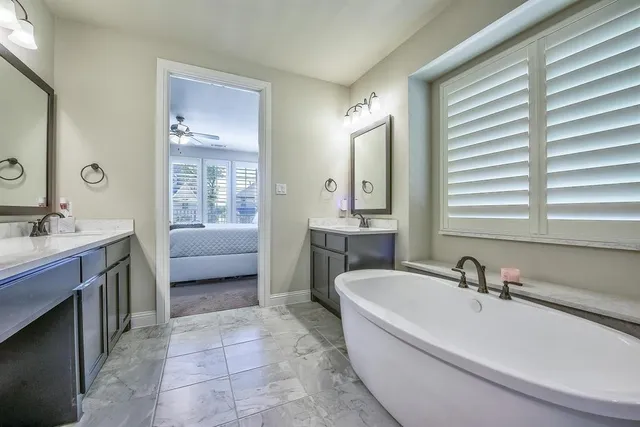 a spacious bedroom with a bed and a ceiling fan