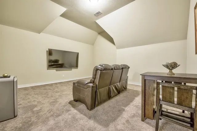 a living room with furniture a window and a potted plant