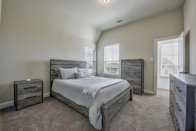 a bedroom with a bed and a potted plant