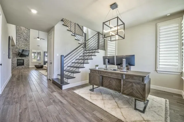 a room with lots of wooden furniture and a chandelier