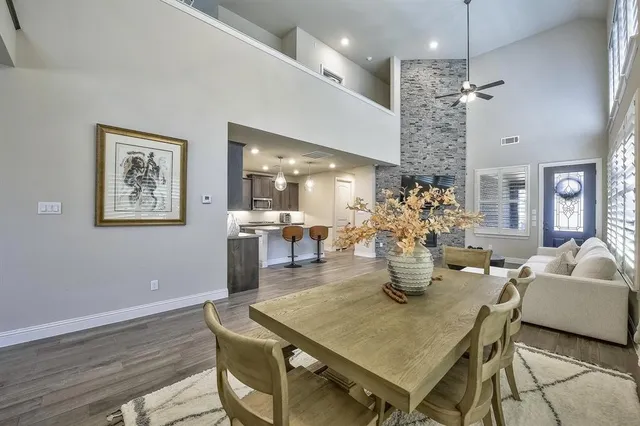 a dining room with furniture a chandelier and wooden floor