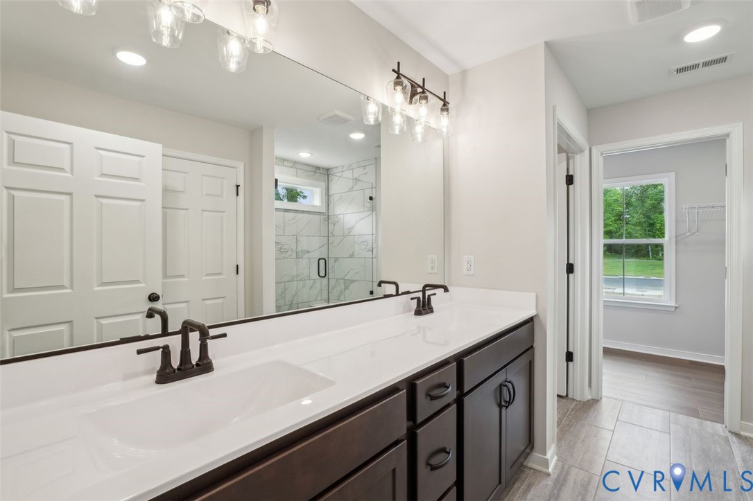 Lot 53 Wendenburg Circle, Unit LOT 53 Aylett, VA 23009 - Photo 19 of 24 a bathroom with a sink a vanity and a mirror