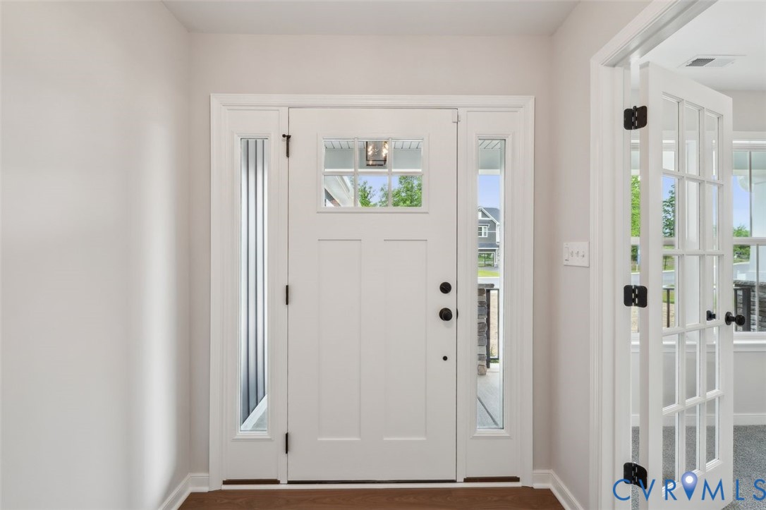 Lot 53 Wendenburg Circle, Unit LOT 53 Aylett, VA 23009 - Photo 3 of 24 a view of a bedroom with wooden floor and door