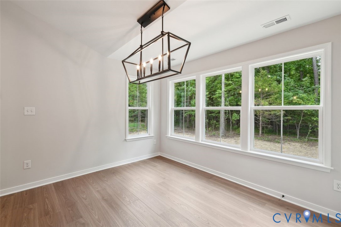 Lot 53 Wendenburg Circle, Unit LOT 53 Aylett, VA 23009 - Photo 9 of 24 a view of an empty room with wooden floor and windows