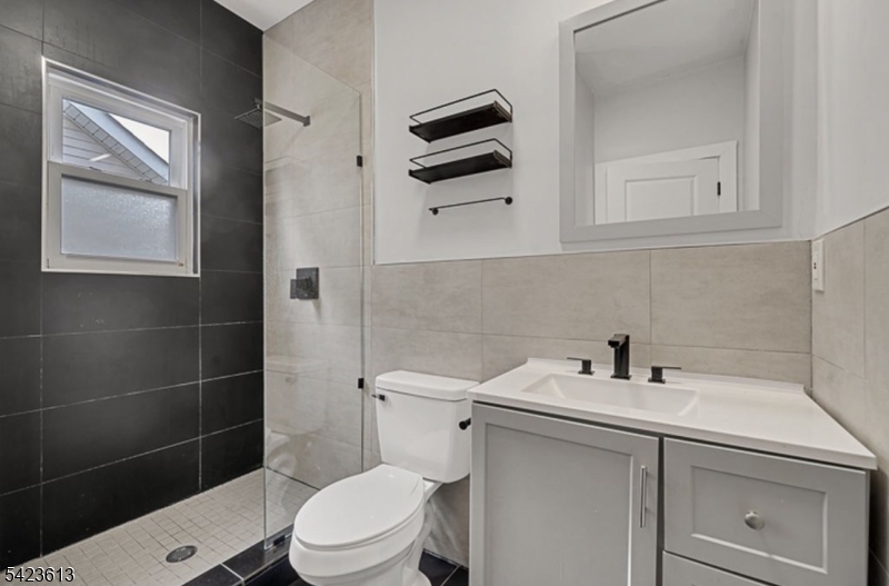 626 South 20th Street, Unit 3 Newark, NJ 07103 - Photo 11 of 13 a bathroom with a sink a toilet and a mirror