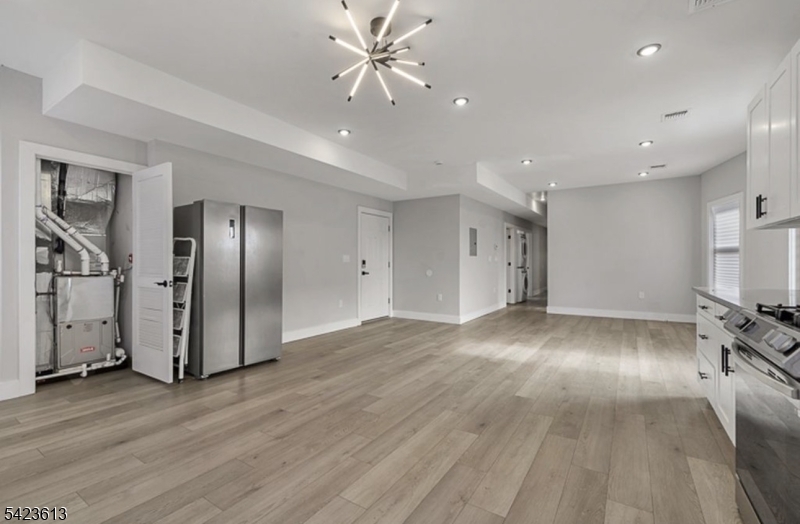 626 South 20th Street, Unit 3 Newark, NJ 07103 - Photo 3 of 13 a view of an empty room with wooden floor and a ceiling fan