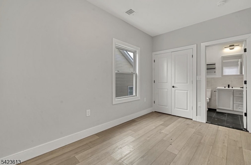 626 South 20th Street, Unit 3 Newark, NJ 07103 - Photo 10 of 13 a view of livingroom with hardwood floor and window