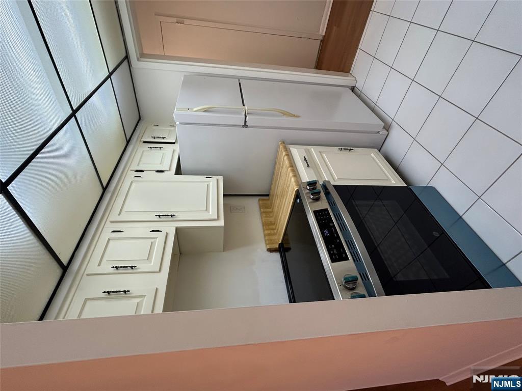 1600 Center Avenue, Unit 5A Fort Lee, NJ 07024 - Photo 4 of 10 a kitchen with cabinets and steel stainless steel appliances