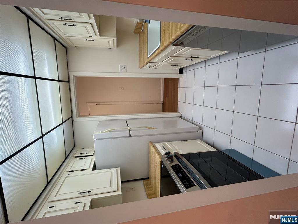 1600 Center Avenue, Unit 5A Fort Lee, NJ 07024 - Photo 5 of 10 a kitchen with stainless steel appliances a stove a sink and a refrigerator