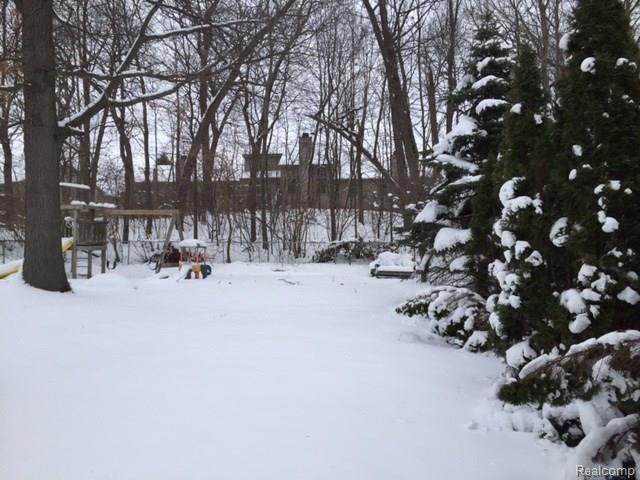 512 Glenwyth Road Brighton, MI 48116 - Photo 14 of 17 fully fenced backyard backs up to woods for privacy